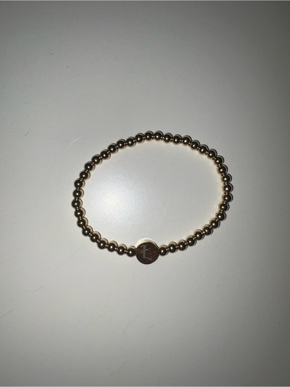 Gold Beaded Initial “L” Disc Stretch Bracelet
